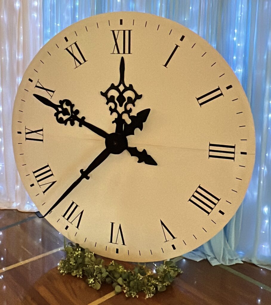 2 metre giant ticking clock prop with Roman numerals styled as a fairytale event backdrop in Auckland