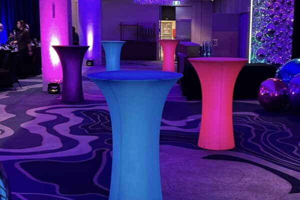 LED cocktail tables glowing pink and blue at an Auckland event venue